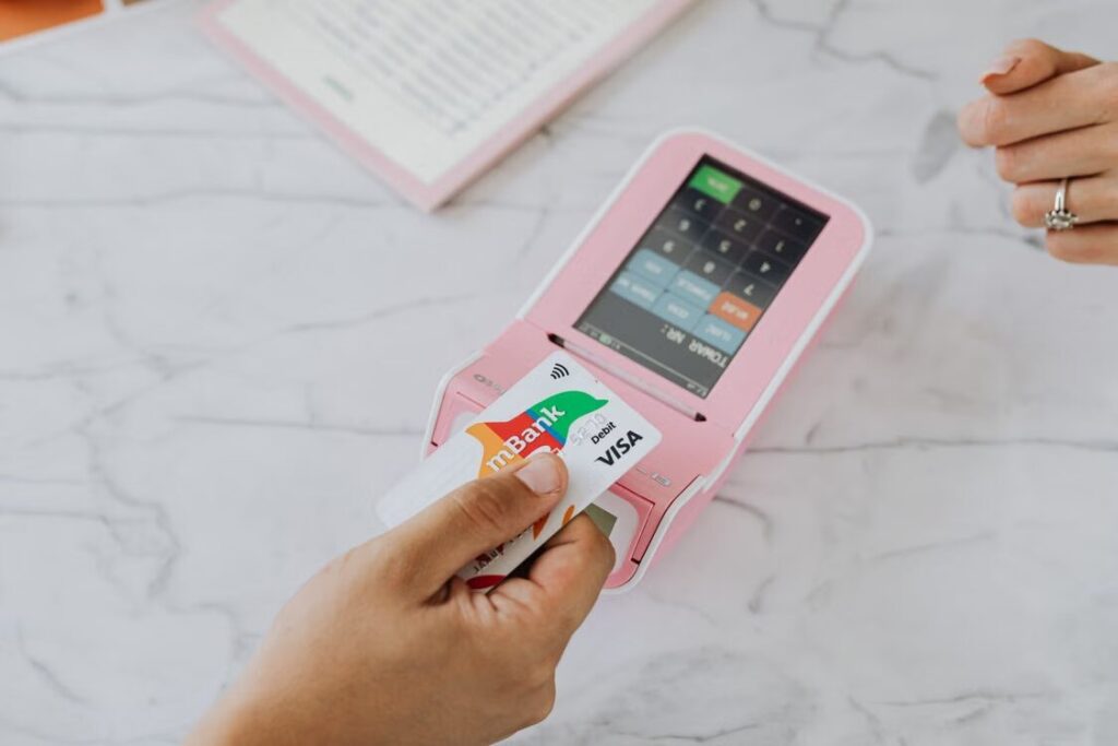 Payment terminal offering a choice between the merchant's local currency and the cardholder's home currency during an international transaction.